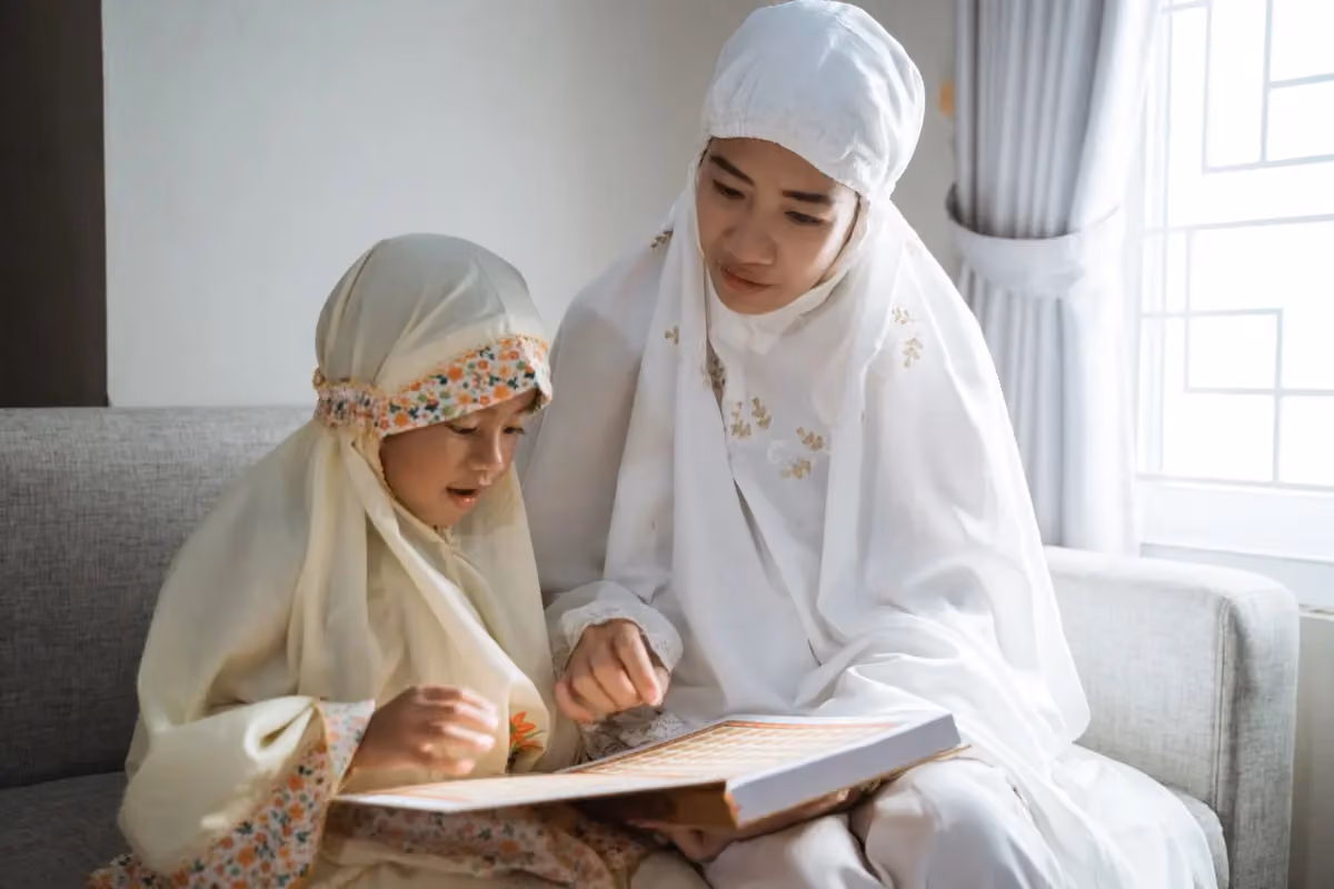 A female Quran teacher reading with a student
